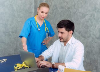 Doctors team examining medical reports at hospital office.