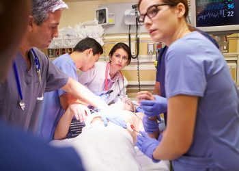 Hard Working Medical Team Working On Patient In Emergency Room