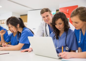 Medical student smiling at the camera during class at the university