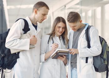 Medical students at the hall. People in a white uniform.
