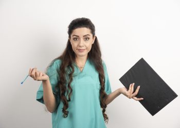 Young nurse with clipboard and pencil. High quality photo